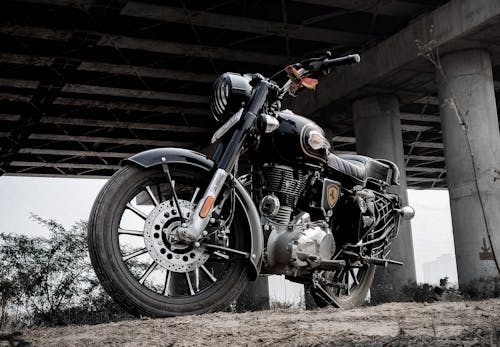 free photo of a motorcycle parked under the bridge